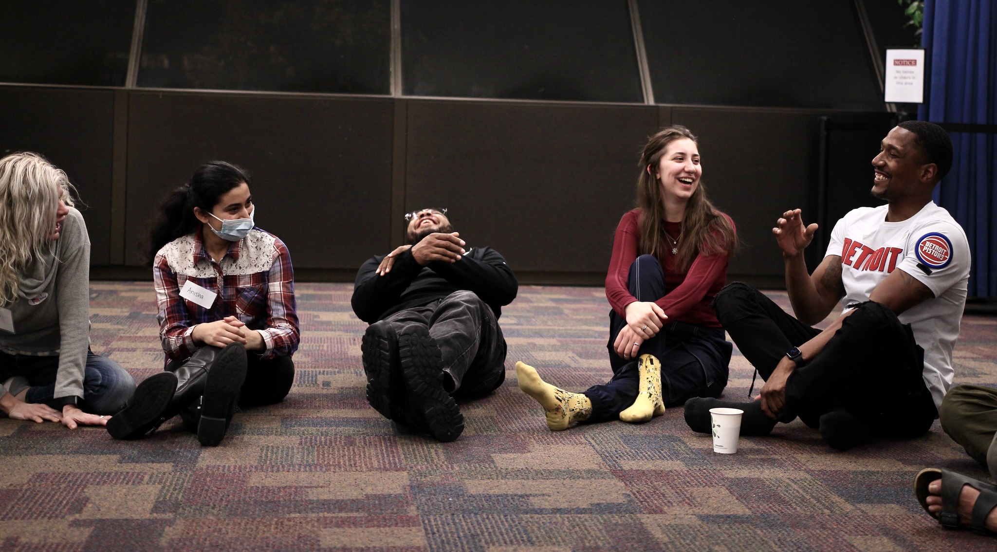 Workshop participants laugh during an icebreaker.