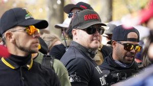 People identifying themselves as members of the Proud Boys join supporters of President Donald Trump for pro-Trump marches, Nov. 14, 2020, in Washington. Two supporter in the center are wearing hats with red lettering that read “RWDS,” which is short for “Right Wing Death Squad.” The gunman who killed eight people on Saturday, May 6, 2023, at a Dallas-area mall was wearing a “RWDS” patch. The phrase has been embraced in recent years by far-right extremists who glorify violence against their political enemies.