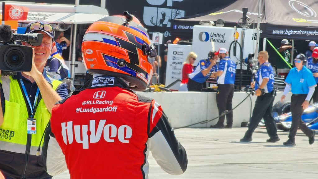 IndyCar driver Christian Lundgaard prepares to get in his car before a practice session in Detroit, Mich.