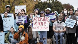 Activists demonstrate as the Supreme Court hears oral arguments on a pair of cases that could decide the future of affirmative action in college admissions, in Washington, Oct. 31, 2022.