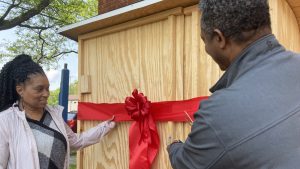 Blanton L. Banks and wife Kimberly cut the ribbon to officially open the community refrigerator.