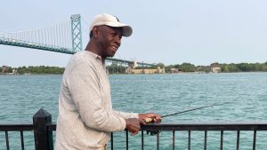 A man fishing in the Detroit River