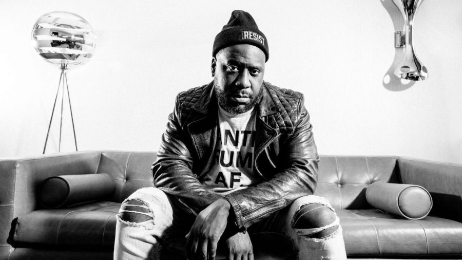 Black and white photo of Robert Glasper sitting on a couch