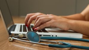 A stock photo of a medical professional on a laptop.