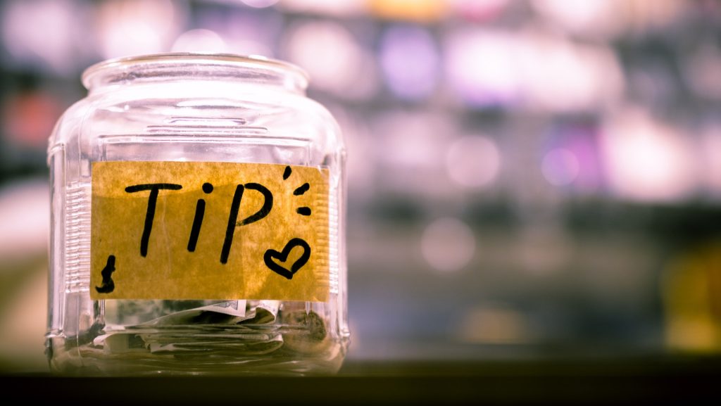 Stock photo of a tip jar.