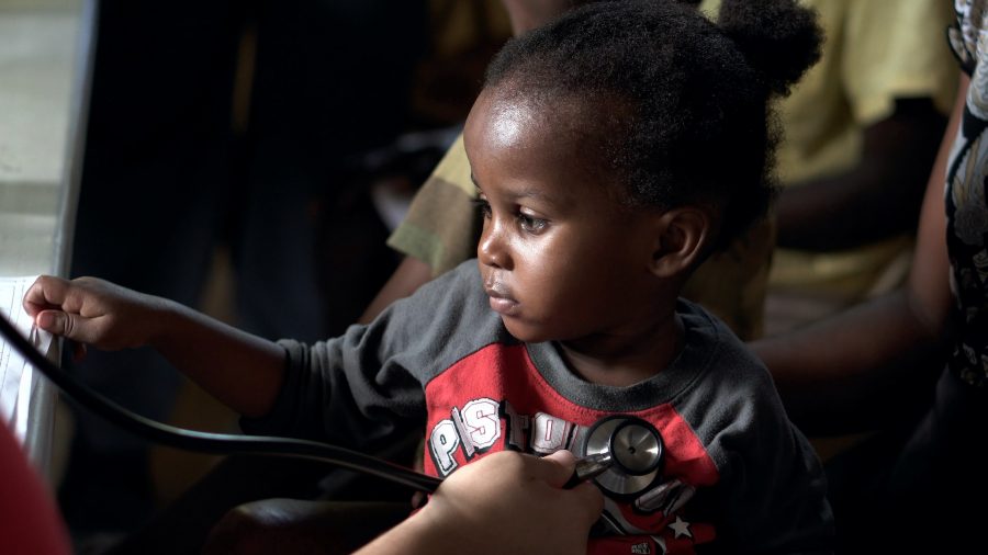 Young Black child receives a doctor's checkup