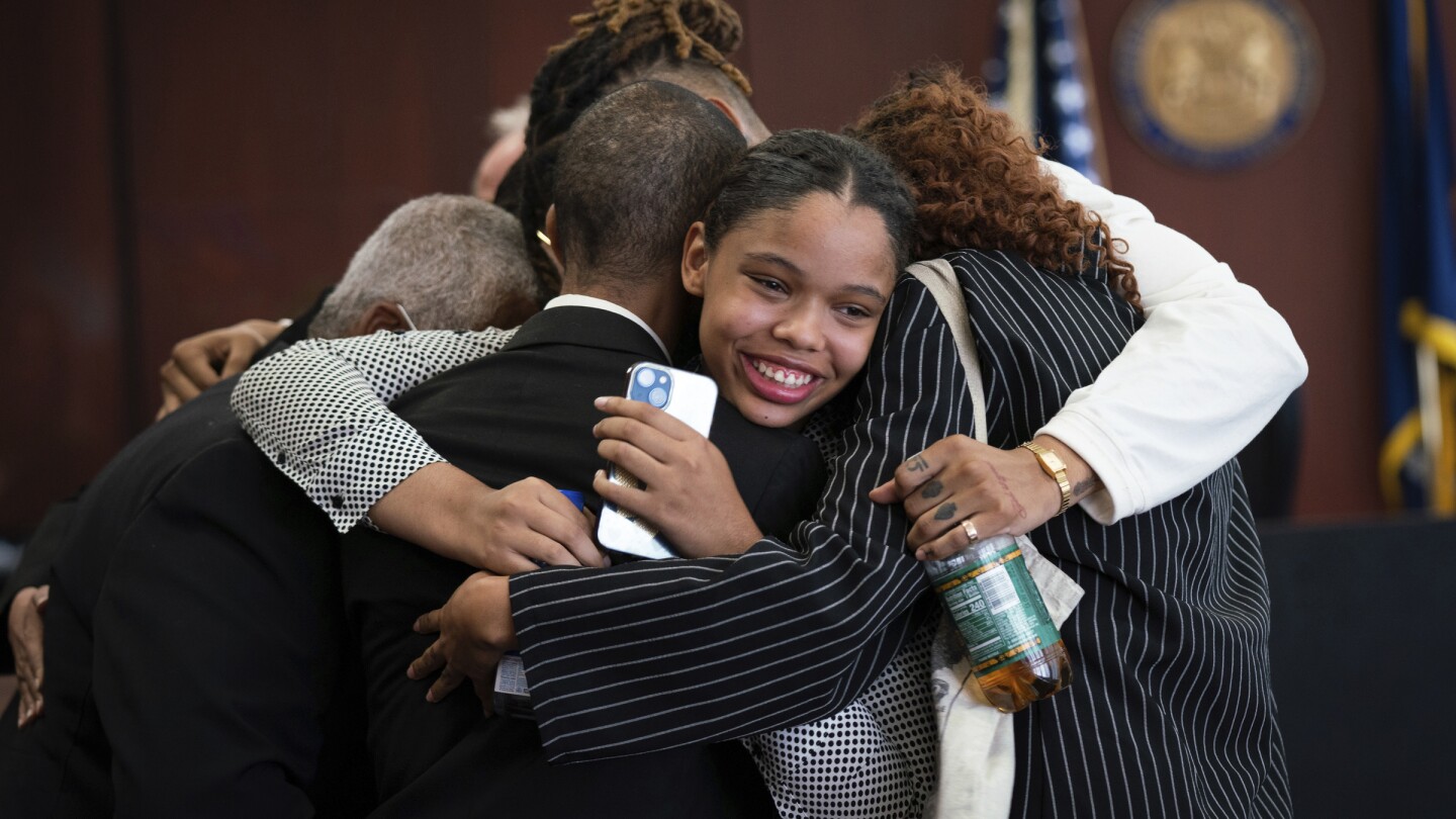 Aretha Franklin's granddaughter Grace Franklin, 17, smiles while embracing her family members after the jury decided in favor of a 2014 document during a trial over her grandmother's wills at Oakland County Probate Court in Pontiac, Mich., on Tuesday, July 11, 2023.