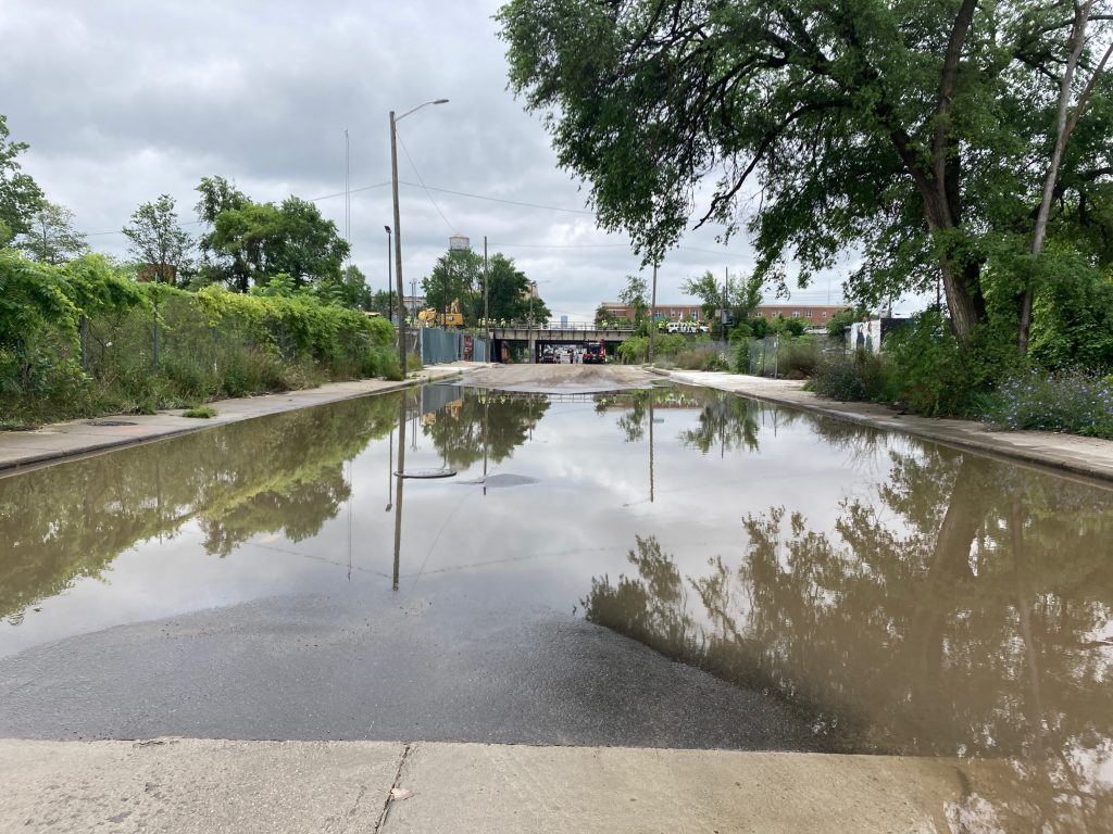 A flooded street in Detroit on a cloudy day