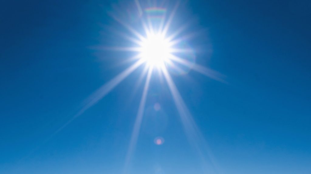 Photo of the sun and blue sky.