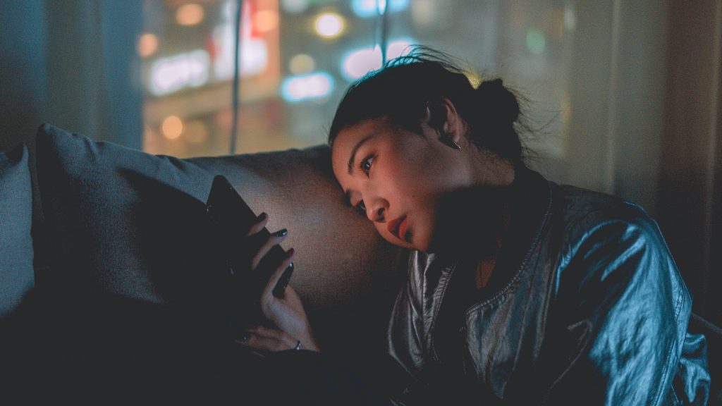 Woman stares at her phone.