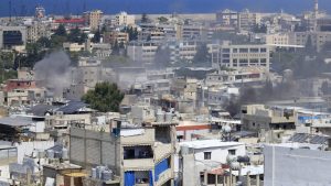 FILE - Smoke rises during a third day of clashes that erupted between members of the Palestinian Fatah group and Islamist factions in the Palestinian refugee camp of Ein el-Hilweh near the southern port city of Sidon, Lebanon, on July 31, 2023.