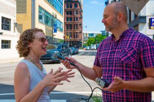 Rabbi Arianna Silverman talks with WDET's Russ McNamara on the street outside the synagogue