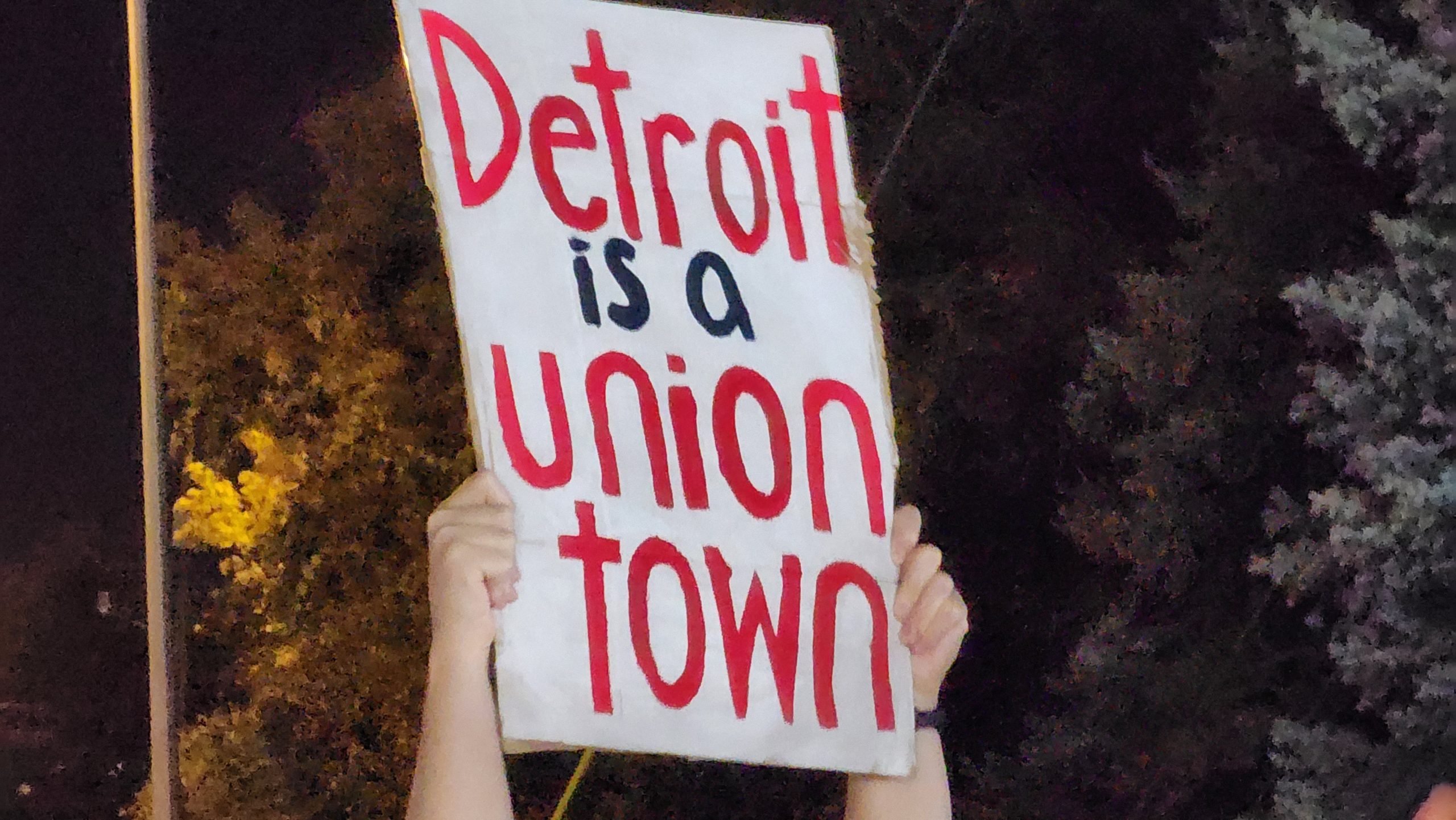 A person holds up a sign that says "Detroit is a union town" on Sept. 15, 2023, in Wayne, Mich.