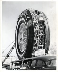 Black and white image of a Ferris wheel designed like a giant tire in 1964