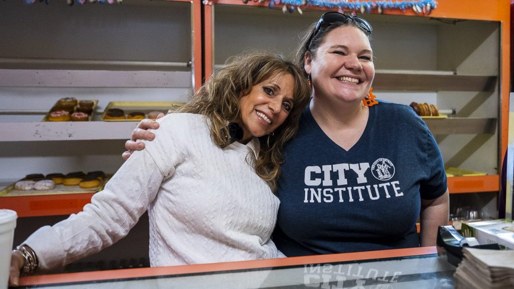 Lydia Gutierrez (left), president of Hacienda Mexican Foods, at Donut Villa with Jeanette Pierce of the City Institute.