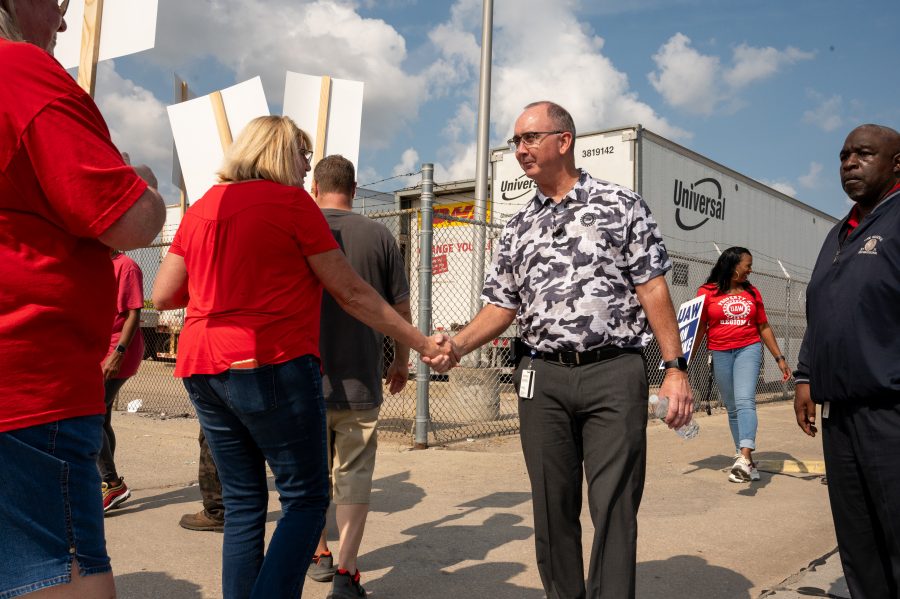 United Auto Workers President Shawn Fain greets striking workers at a Mopar Parts Distribution Center in Center Line, Michigan.