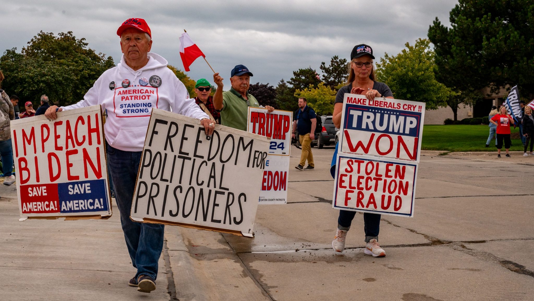 Supporters of former President Donald Trump gather outside a rally in Clinton Township on September 27, 2023.