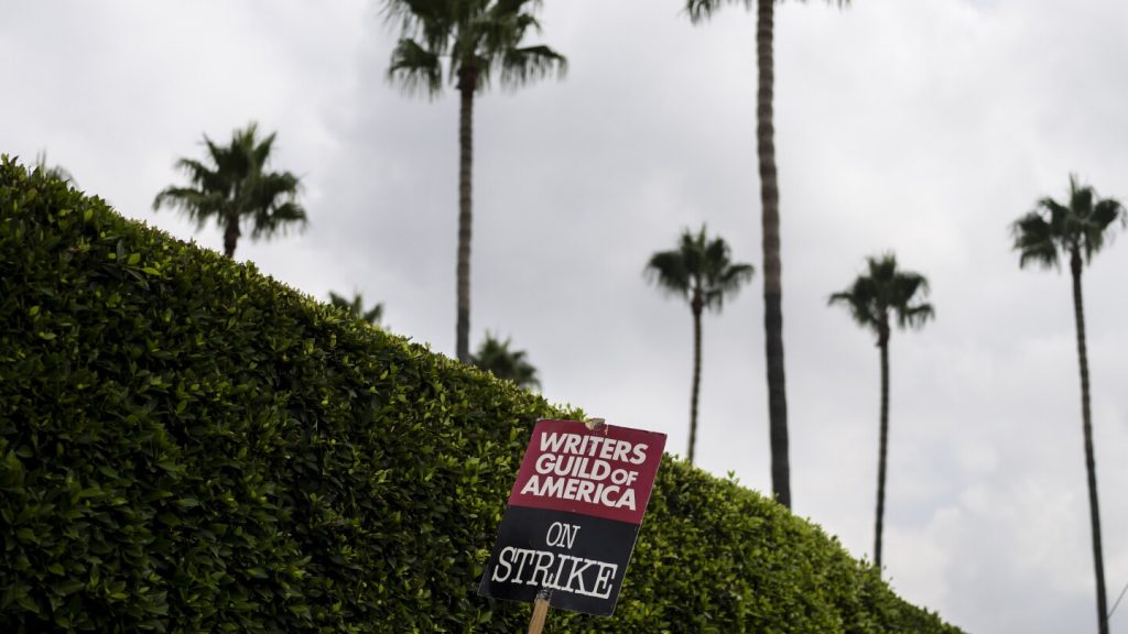 FILE - A demonstrator holds up a sign during a rally outside the Paramount Pictures Studio in Los Angeles, Thursday, Sept. 21, 2023.