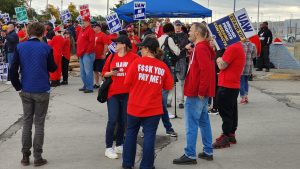 UAW members strike outside of Ford's Michigan Assembly Plant in Wayne, Mich.
