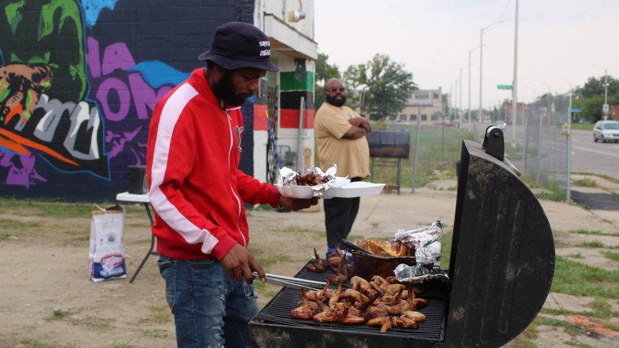 Mario Timmons (left) and Frederick Lamar grill chicken wings at their pop-up on Dexter Avenue in Detroit.