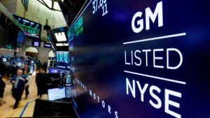 FILE - In this April 23, 2018, file photo, the logo for General Motors appears above a trading post on the floor of the New York Stock Exchange. General Motors reports earnings on Tuesday, Oct. 24, 2023.