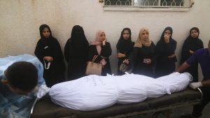 Palestinian women stand next to the body of a person killed in the Israeli bombing of the Gaza Strip in Rafah on Tuesday, Oct. 24, 2023.