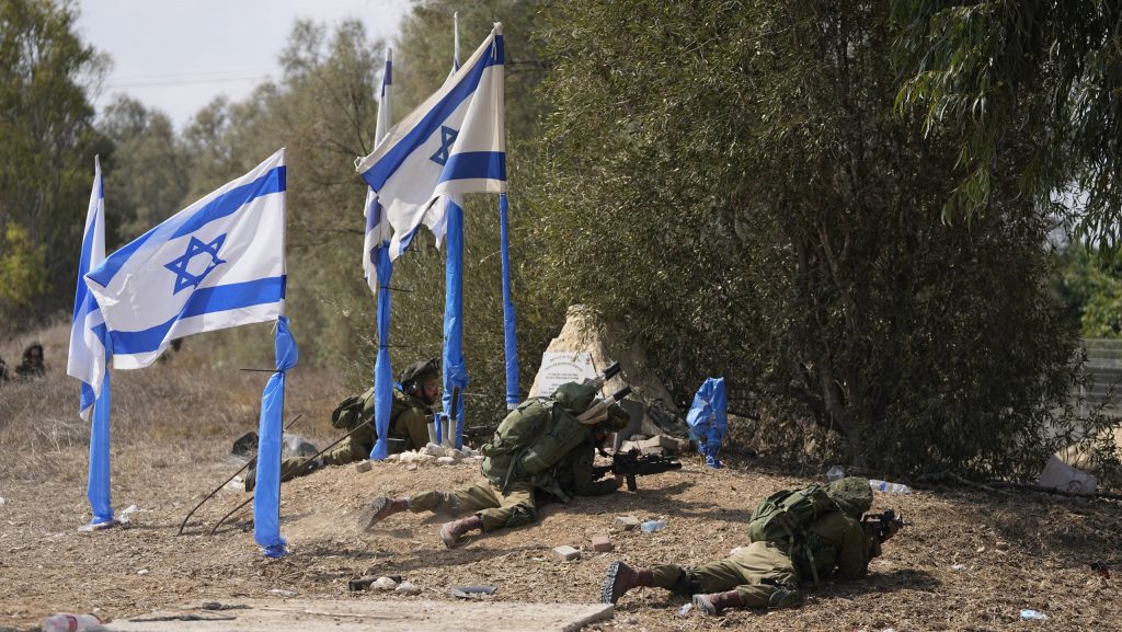 Israeli soldiers take positions in kibbutz Kfar Azza on Tuesday, Oct. 10, 2023, after Hamas militants overran the area killing many Israelis and taking some captive.