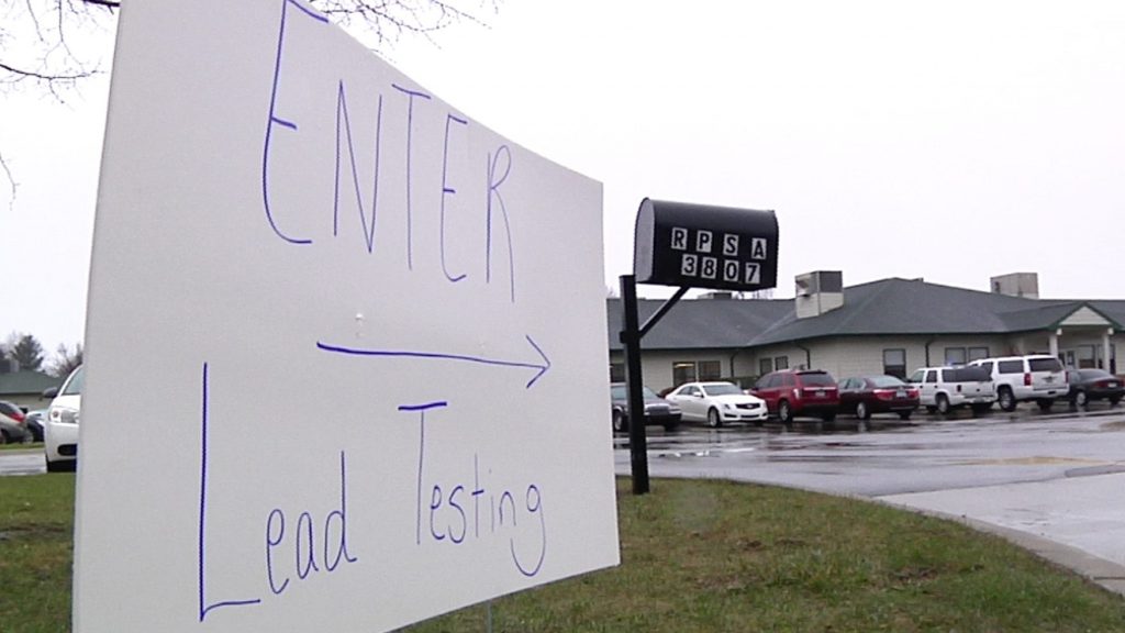 This Thursday, March 24, 2016, image from video shows a hand-written sign placed at the entrance to a lead-testing clinic held at Richfield Public School Academy in Flint, Mich. Thousands of Flint parents have had their children tested at free clinics run by the Genesee County Health Department since residents became aware that their water had become contaminated with lead after the city began drawing water from the Flint River to save money.