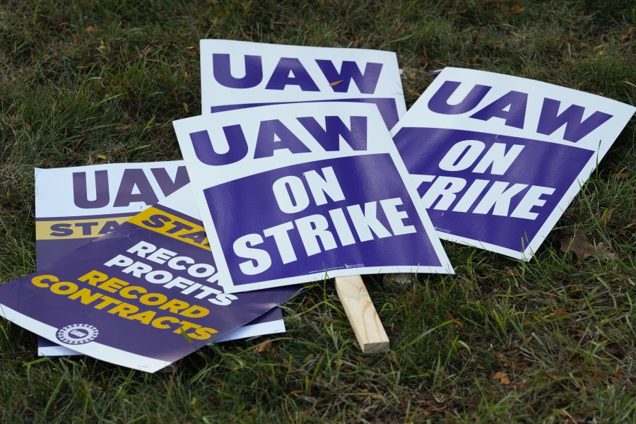 FILE - United Auto Workers signs for a strike are shown at the Stellantis Sterling Heights Assembly Plant, in Sterling Heights, Mich., Monday, Oct. 23, 2023.
