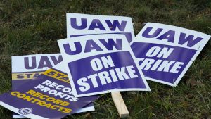 FILE - United Auto Workers signs for a strike are shown at the Stellantis Sterling Heights Assembly Plant, in Sterling Heights, Mich., Monday, Oct. 23, 2023.