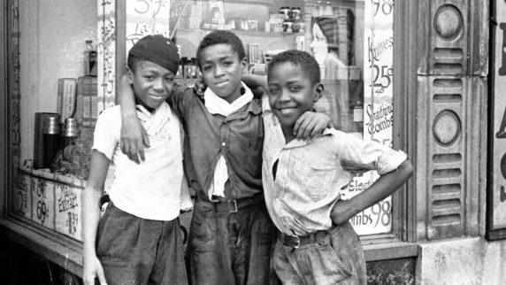 Three boys, identities unknown, pose in front of a five and dime store in Detroit’s Near East Side. The area includes the Brush Park, Paradise Valley, and Black Bottom neighborhoods, 1930s-1940s.