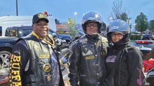 Buffalo Soldiers member Zo Hall (left) stands with fellow members at a motorcycle club event.