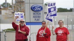 FILE - United Auto Workers members walk the picket line at the Ford Michigan Assembly Plant in Wayne, Mich., Sept. 26, 2023.