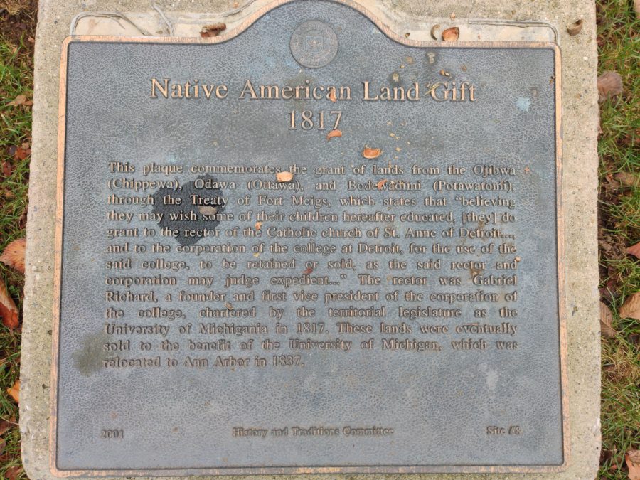 A historic plaque acknowledging the gift of land formerly held by Native American groups to the University of Michigan, located just north of the Diag, between the School of Kinesiology Building and the Chemistry Building.