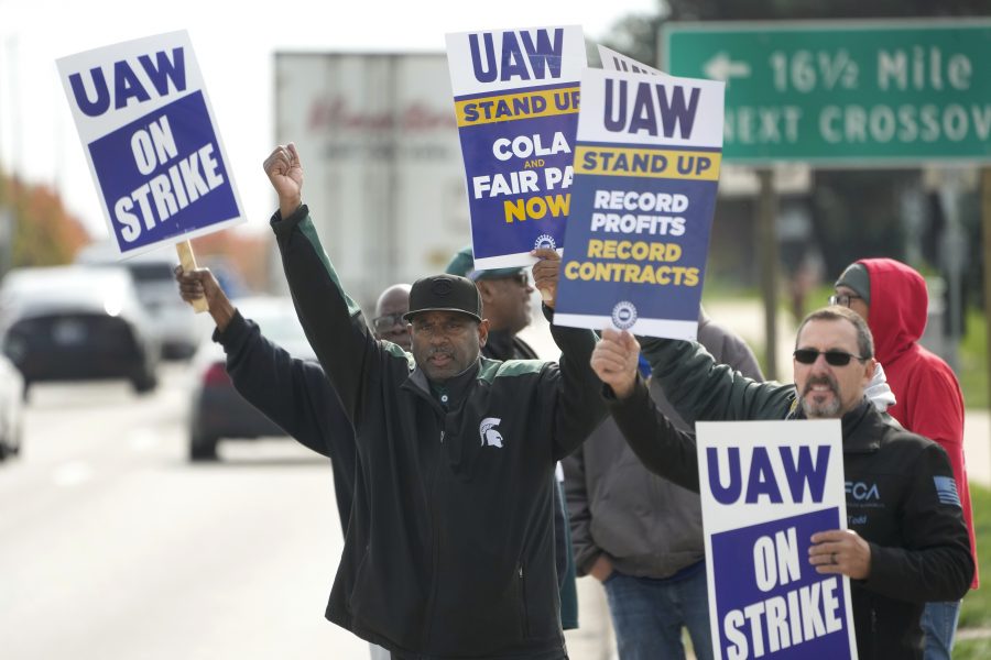 FILE - United Auto Workers members walk the picket line during a strike at the Stellantis Sterling Heights Assembly Plant, in Sterling Heights, Mich., Monday, Oct. 23, 2023.
