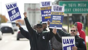 FILE - United Auto Workers members walk the picket line during a strike at the Stellantis Sterling Heights Assembly Plant, in Sterling Heights, Mich., Monday, Oct. 23, 2023.