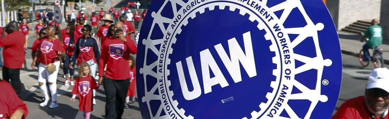 FILE - United Auto Workers members walk in the Labor Day parade in Detroit, Sept. 2, 2019.