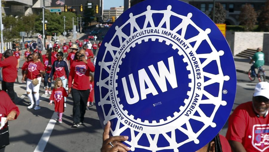 FILE - United Auto Workers members walk in the Labor Day parade in Detroit, Sept. 2, 2019.