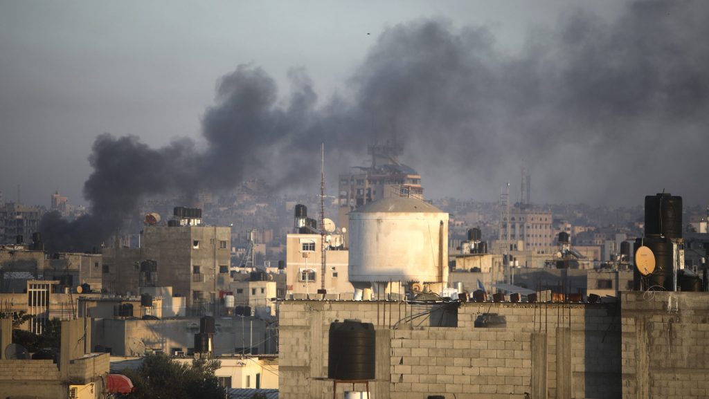 Smoke rises from town of Khan Younis after Israeli strikes on Friday, Dec. 15, 2023.