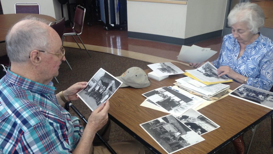 Royce and Kathy Richards look through photos of when they transported the Garland stove to the Michigan State Fair grounds.