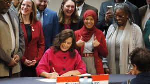 Gov. Gretchen Whitmer signs one of 23 bills to expand voting rights in Michigan. One of the new laws requires campaign ads to indicate if they make substantial use of AI technology.