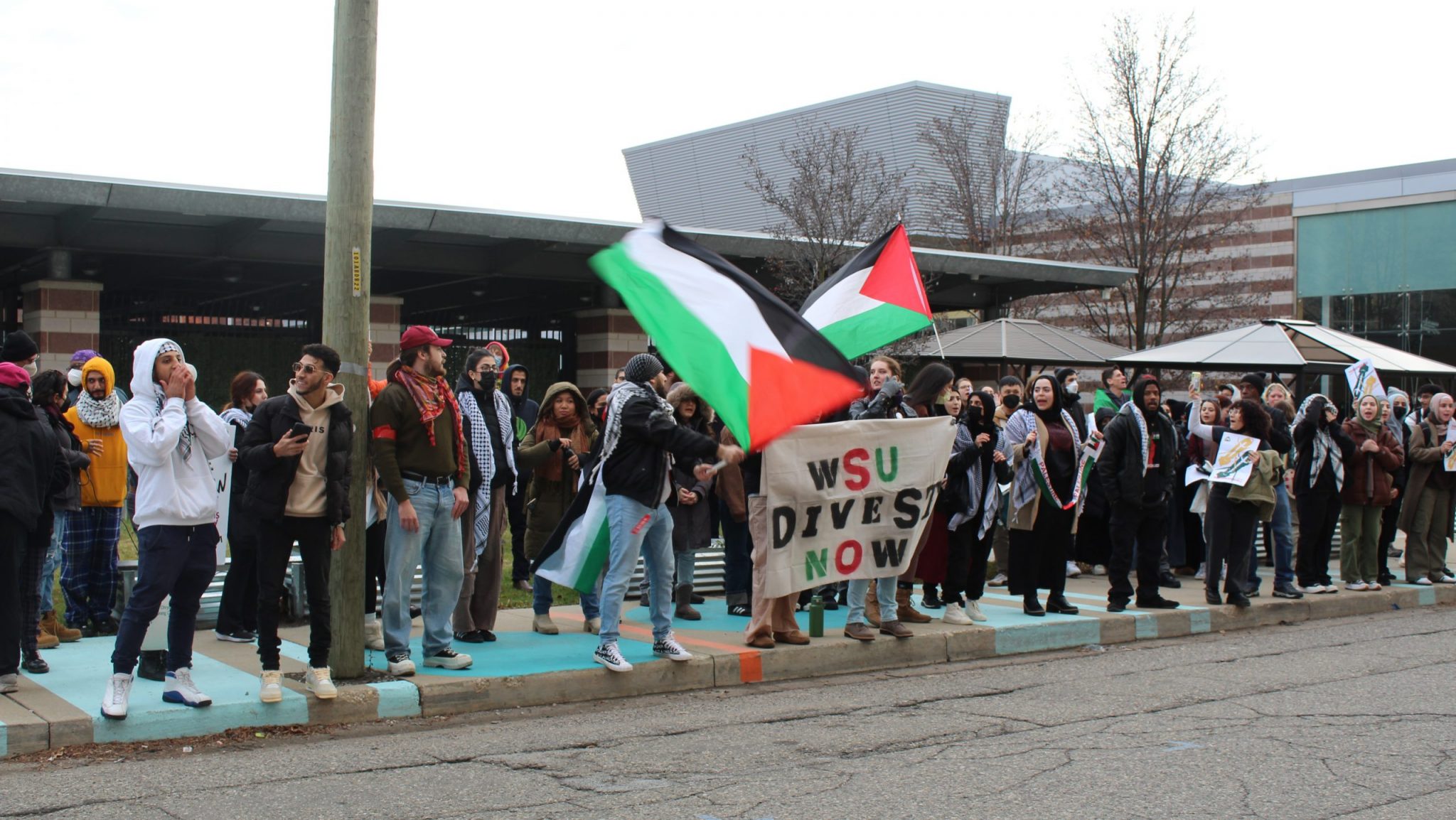 Students gathered outside the Wayne State University Board of Governors meeting on Thursday, Dec. 7, to demand the university's divestment from companies that profit from war.