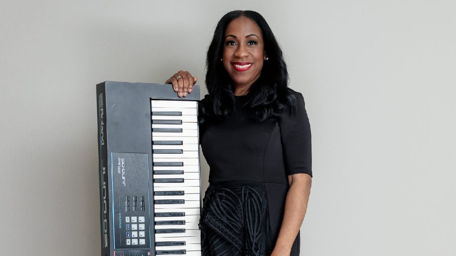 Candace Nicole poses with a Roland keyboard