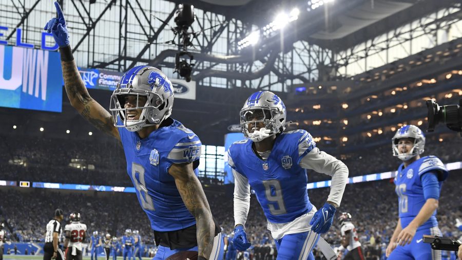 Detroit Lions wide receiver Josh Reynolds (8) celebrates with teammates Jameson Williams (9) and Jared Goff (16) after scoring a touchdown against the Tampa Bay Buccaneers during the first half of an NFL football NFC divisional playoff game, Sunday, Jan. 21, 2024, in Detroit. (AP Photo/Jose Juarez)