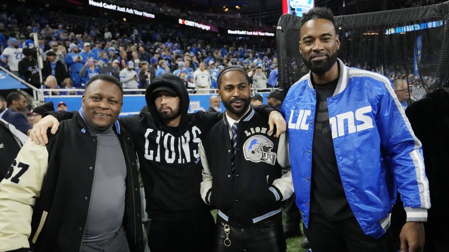 From left, former Detroit Lions running back Barry Sanders stands with musicians Eminem and Big Sean and former receiver Calvin Johnson during pregame of an NFL wild-card playoff football game against the Los Angeles Rams, Sunday, Jan. 14, 2024, in Detroit.