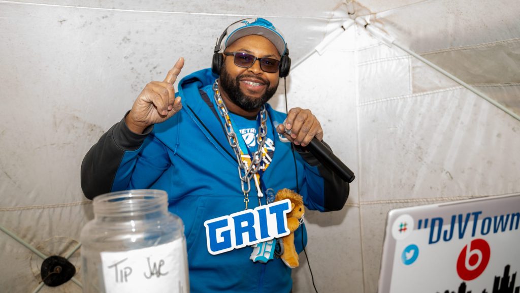 A DJ decked out in Lions gear at a tailgate