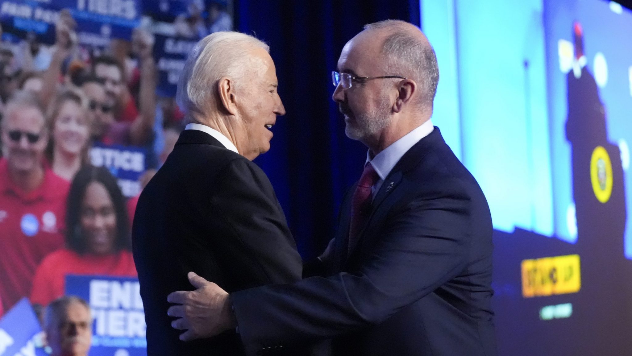 President Joe Biden is greeted by Shawn Fain, president of the United Auto Workers, as he arrives to speak to a United Auto Workers' political convention, Wednesday, Jan. 24, 2024, in Washington.