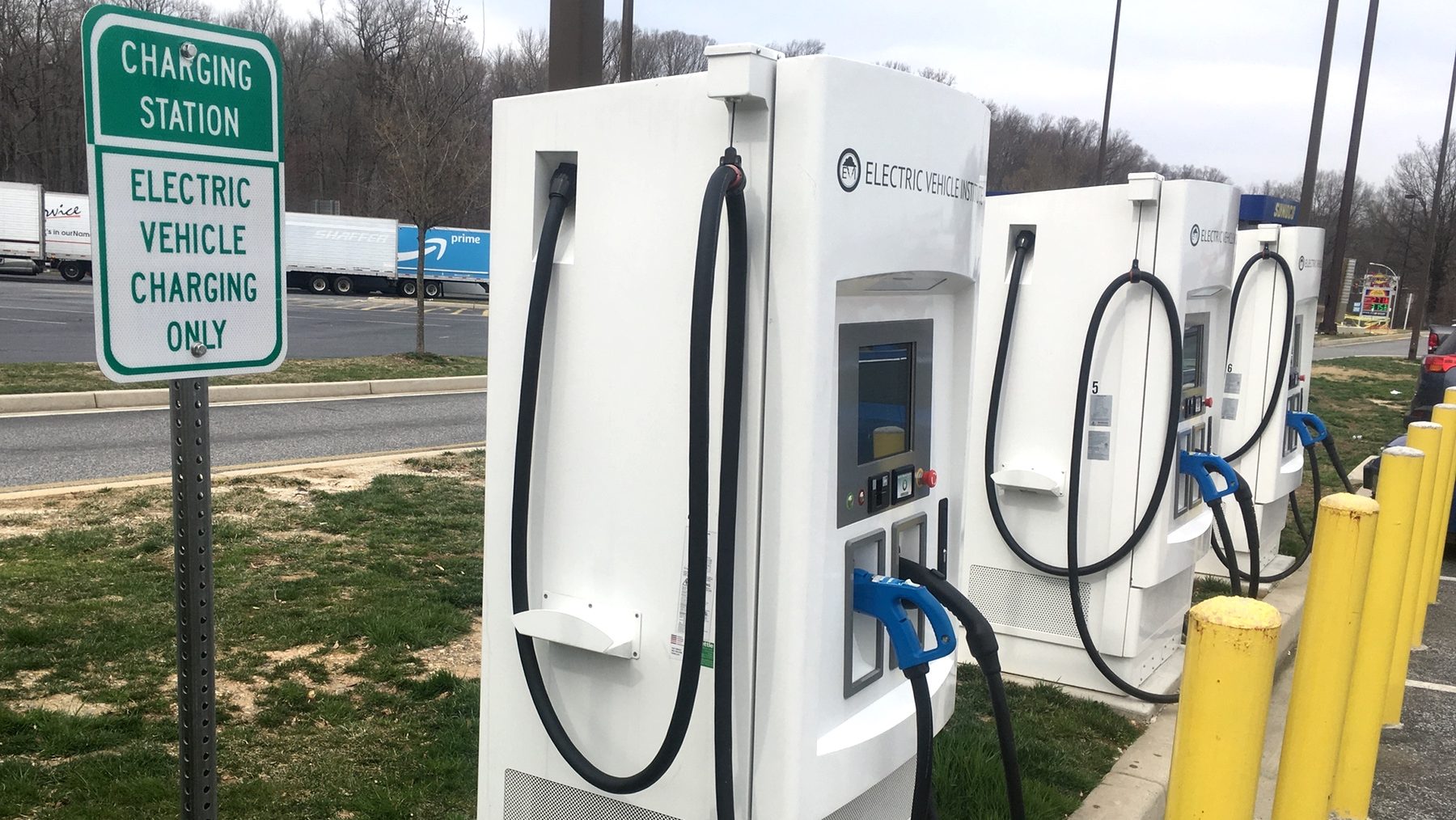 FILE - Electric vehicle charging stations at a freeway rest stop.