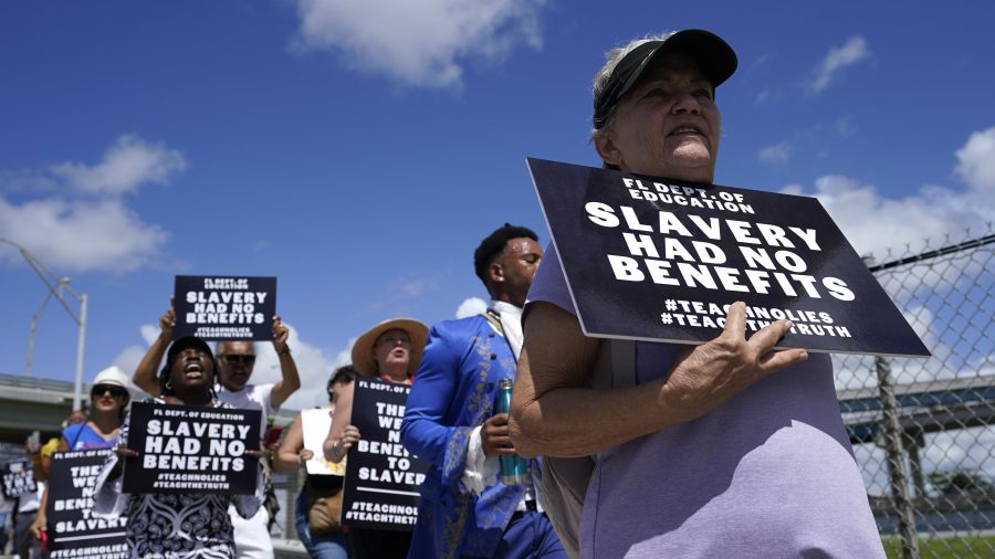 People participate in the "Teach No Lies" march to the School Board of Miami-Dade County to protest Florida's new standards for teaching Black history, which have come under intense criticism for what they say about slavery, Wednesday, Aug. 16, 2023, in Miami.