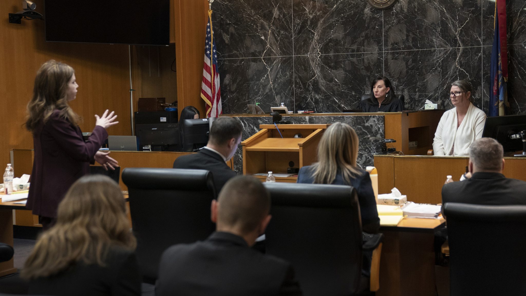 Defense attorney Shannon Smith, left, speaks to her client Jennifer Crumbley, back right, on the stand in the Oakland County courtroom on Thursday, Feb. 1, 2024, in Pontiac, Mich.